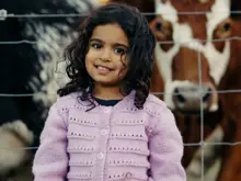 Young child visiting the animals at Walter Peak Farm.
