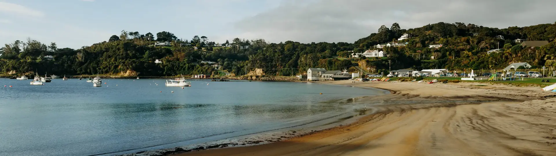 Sheltered beach and boats in the coastal settlement of Oban.