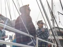 Guests enjoying the view from the deck of an expedition vessel.