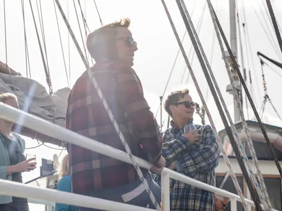 Guests enjoying the view from the deck of an expedition vessel.