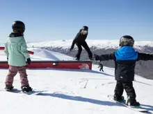 Skiers and snowboarders enjoying the terrain park at Cardrona Alpine Resort.