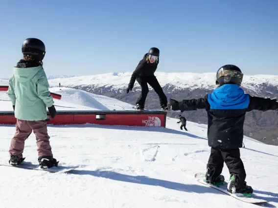Skiers and snowboarders enjoying the terrain park at Cardrona Alpine Resort.