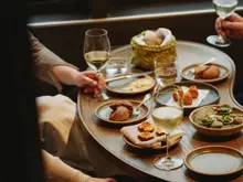 Guests sharing a meal inside a Milford Sound cruise vessel.